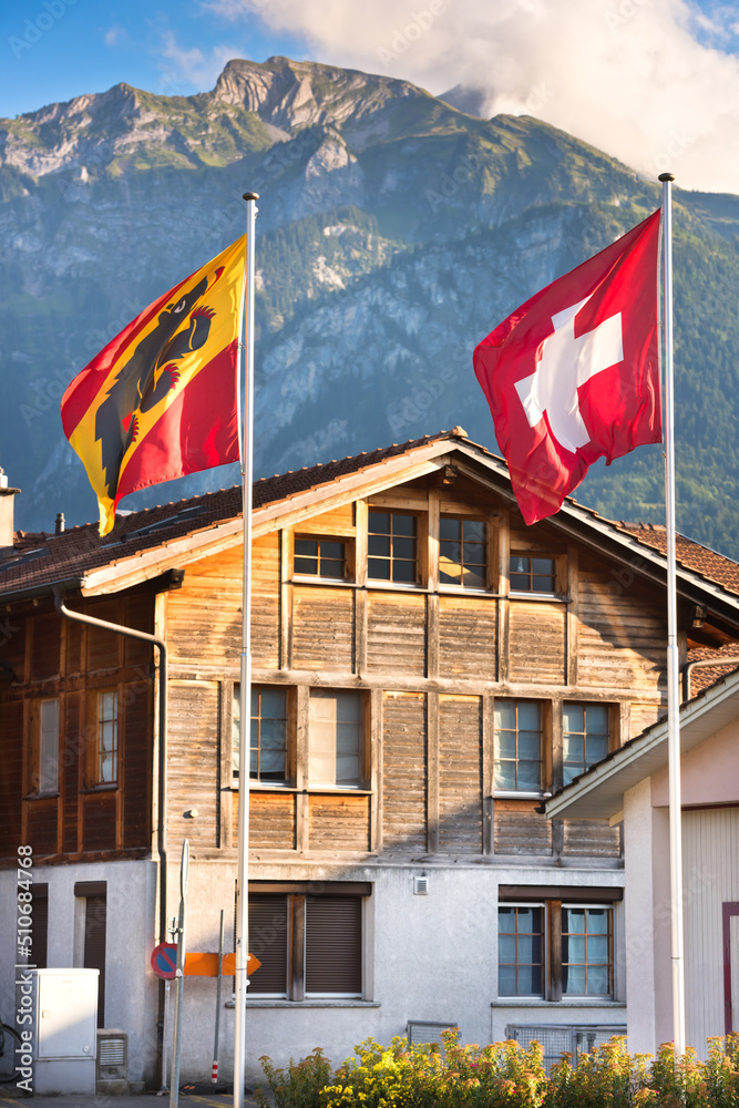 Fluttering Swiss and Bernese Oberland region flags