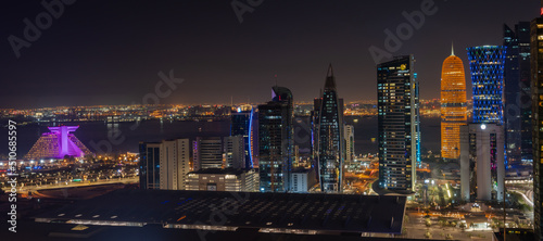 Doha city with many colorful towers during night. photo