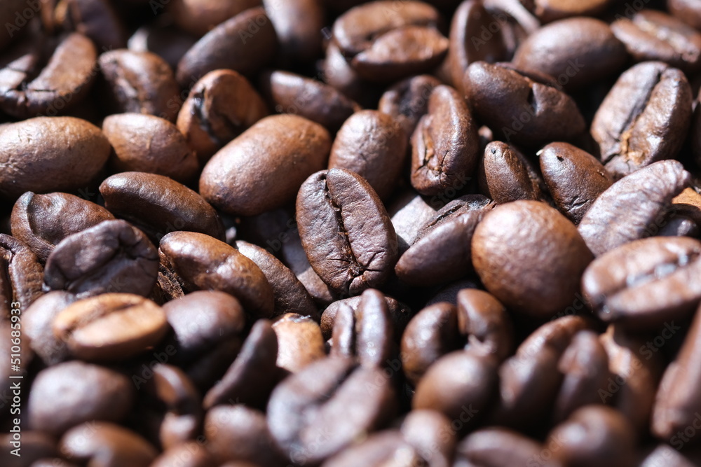 Coffee roasted beans closeup, coffee macro close up, selective focus. Defocused natural blurred background. Coffee roasted beans closeup, coffee macro close up, selective focus. Defocused natural blurred background.