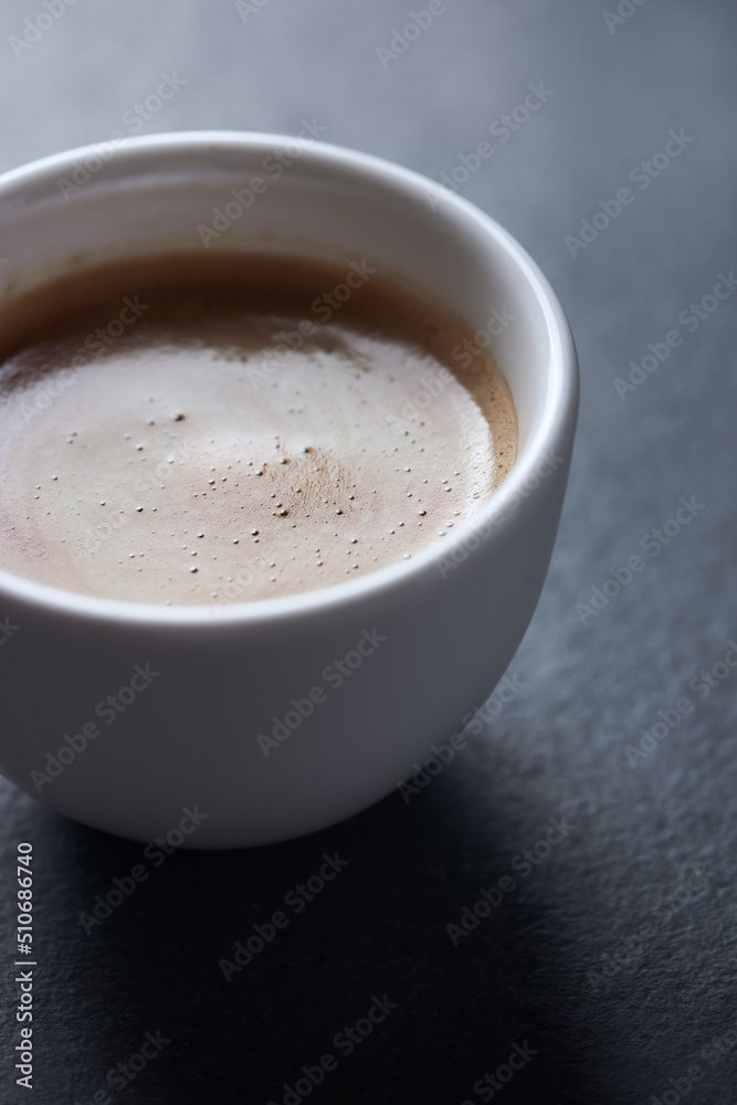Cup of coffee on dark stone background. Close up. Copy space.	