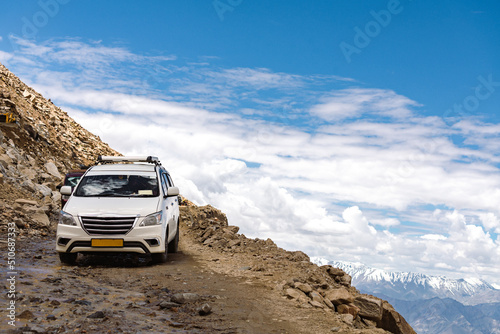 A tourist car traverses a small mountain pass