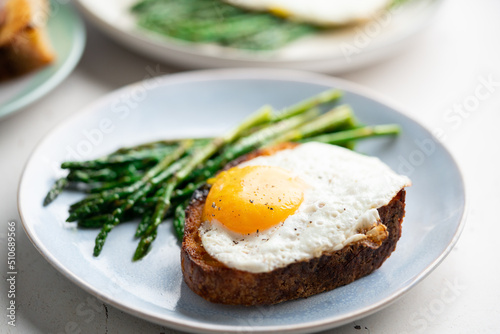 Fried eggs with toasted bread and green asparagus. Fast lunch ideas, healthy breakfast, summer food.