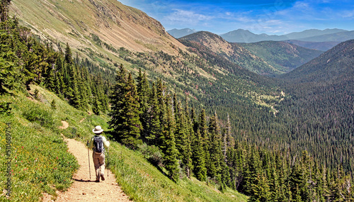 Photo Hiker descending the Arapaho Pass Trail in Colorado's Indian Peaks Wilderness, Boulder County
