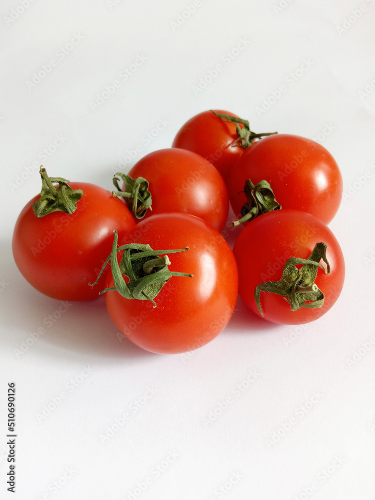 small bright cherry tomatoes on a white background small bright cherry tomatoes on a white background
