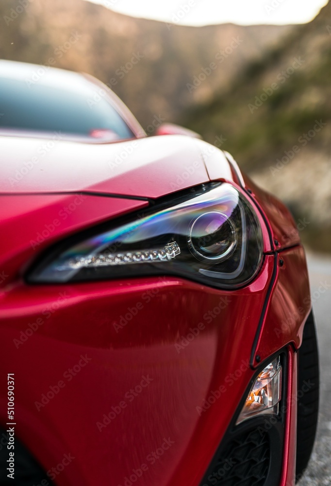 Drivers side front headlight on a red car Drivers side front headlight on a red car