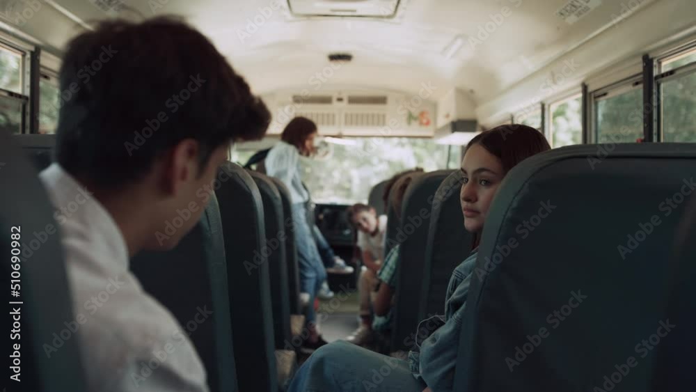 Multiethnic classmates chatting ride school bus. Kids wait schoolmates to board. Multiethnic classmates chatting ride school bus. Kids wait schoolmates to board.