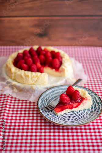 Delicious slice of cheesecake decorating with raspberries