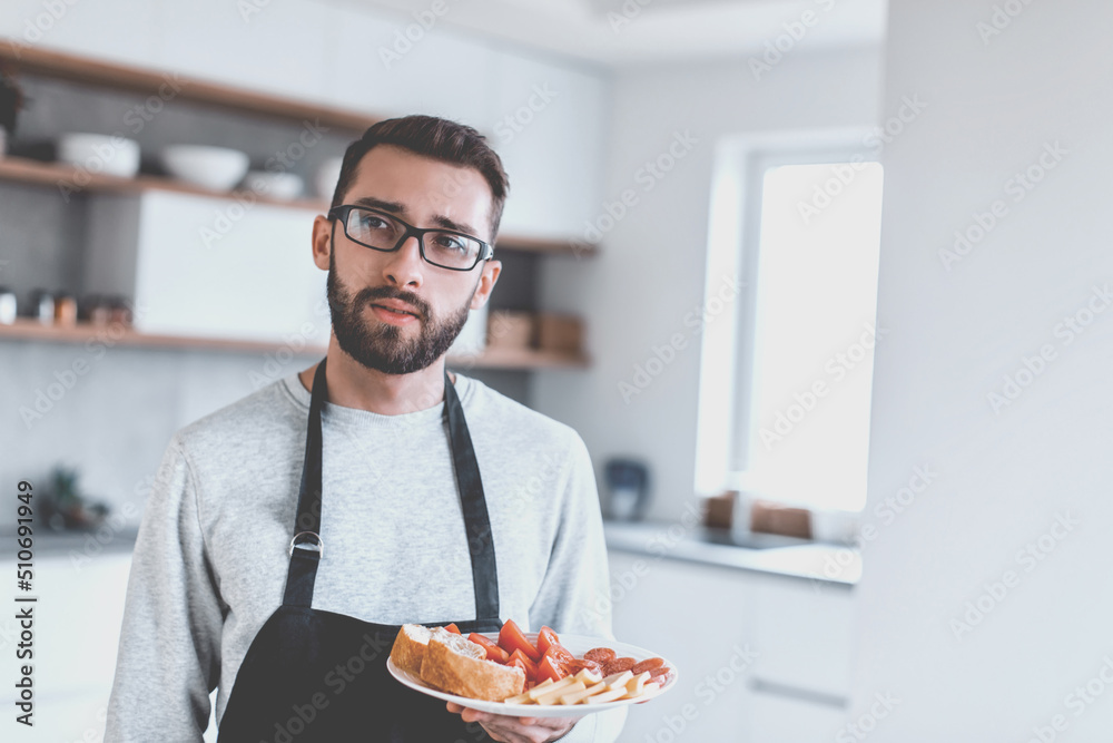 plate of sandwiches in the hands of an attractive man plate of sandwiches in the hands of an attractive man