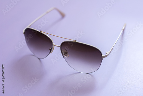 Aviator glasses on a purple background, fashion glasses, glasses with gradient lenses