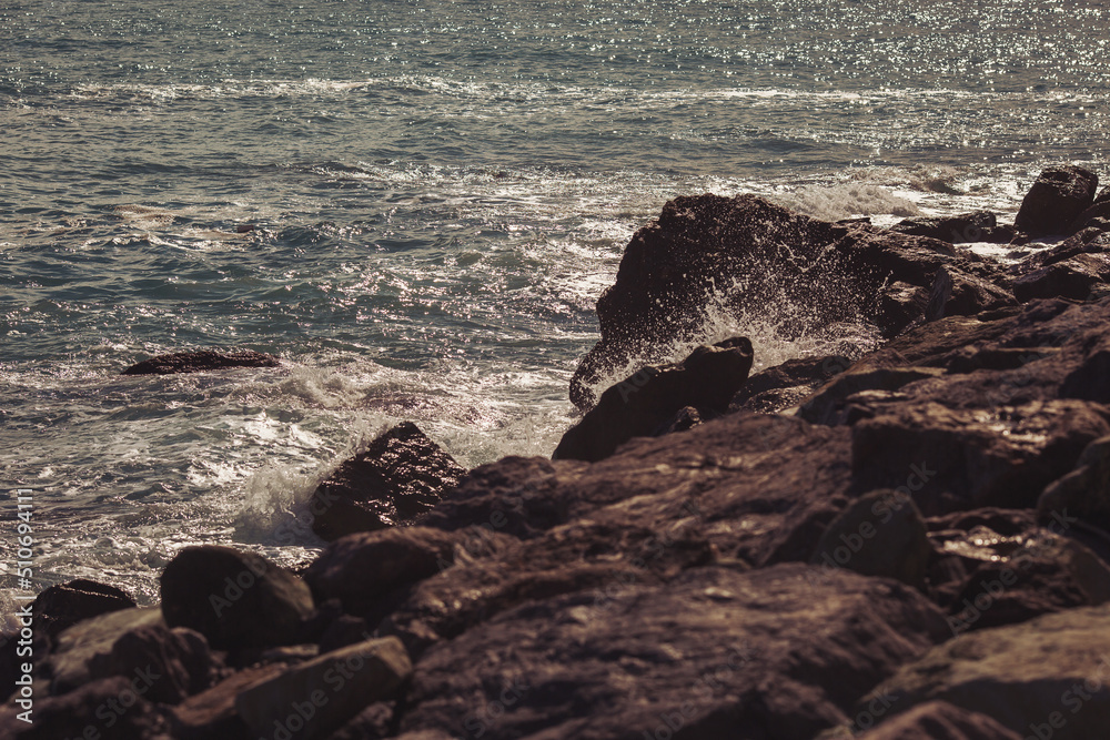 Marine motifs. Waves splashes on rock in sea shore, pretty calm sea. Marine motifs. Waves splashes on rock in sea shore, pretty calm sea.