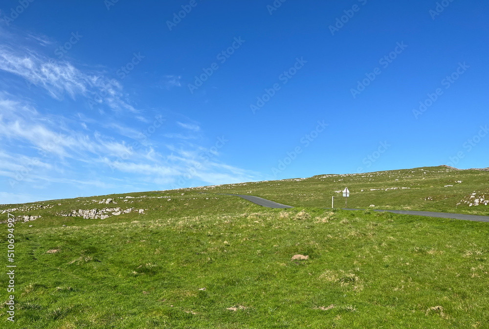 Landscape view, across Malham Moor, with the, Clitheroe to Skipton road leading to the horizon near, Settle, UK