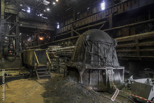 Slag carrier wagon in iron factory workshop.