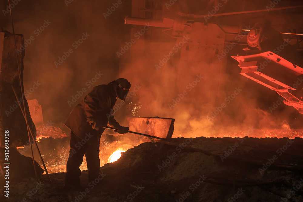 Fototapeta premium Man works in blast furnace area workshop.