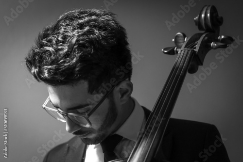 Classic cello player performing with suit