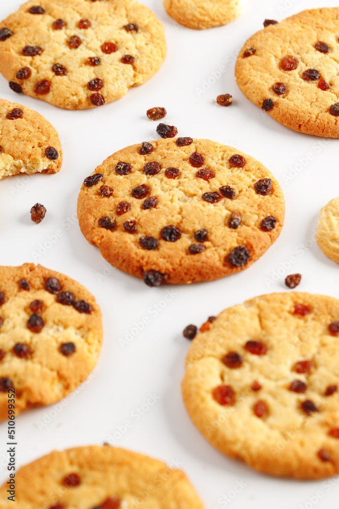 Chocolate american cookies with chocolate chips and raisins on white wooden table. Top view, flat lay.