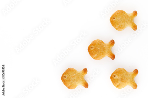 Photography Yellow fish crackers on isolated white background. Close-up.