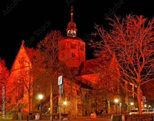 Evangelical Lutheran Cathedral of St Boniface in red lights, Hamelin, Germany photo