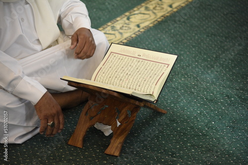 The Holy Qur’an on a wooden stand in the mosque, prayer and supplication in the mosque, worship and getting closer to God