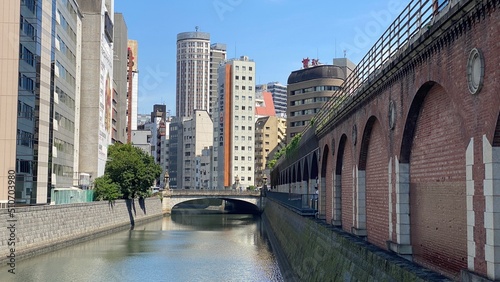 The bridge at Kanda river Ochanomizu “Shoheibashi”,  the old brick base of train tracks are turned into restaurants and shopping district, the long river of Kanda, year 2022 June 13th