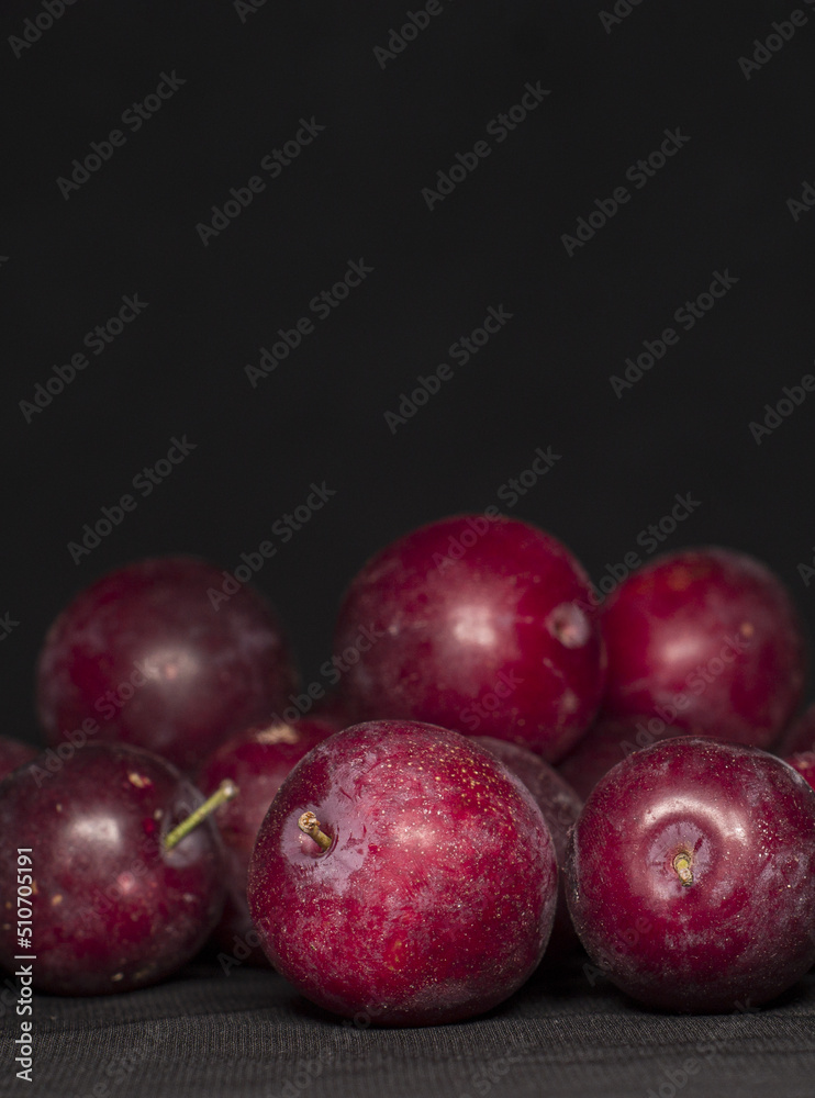 Obraz premium plums with black background