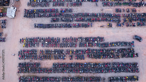 Yard of abandoned cars and seized for irregularity by the police. With many cars and many motorcycles parked. Aerial view photo