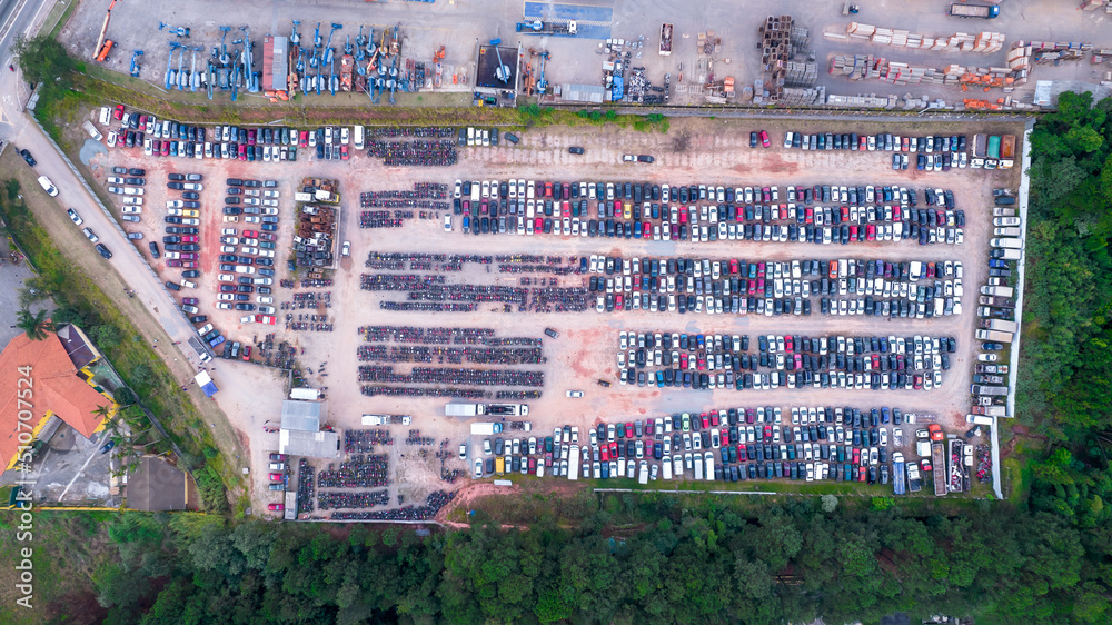 Yard of abandoned cars and seized for irregularity by the police. With many cars and many motorcycles parked. Aerial view