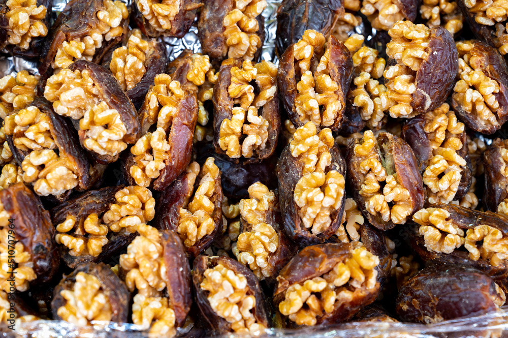 Turkish or arabic sweet dessert, ripe dried dadels with walnuts sweetened with syrup or honey. Turkish or arabic sweet dessert, ripe dried dadels with walnuts sweetened with syrup or honey.