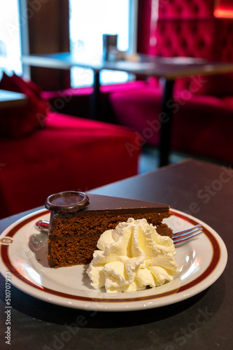 Photography Piece of famous Sachertorte chocolate cake with apricot jam of Austrian origin s