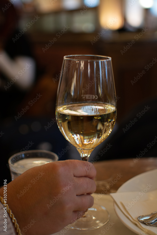 Lifestyle of beautiful Vienna, glass of white dry Austrian wine served in old Viennese-style cafe in Vienna, Austria