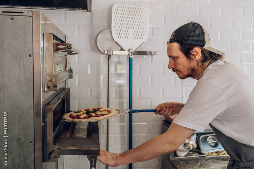 Portrait of a kitchen chef working in a pizza place Portrait of a kitchen chef working in a pizza place