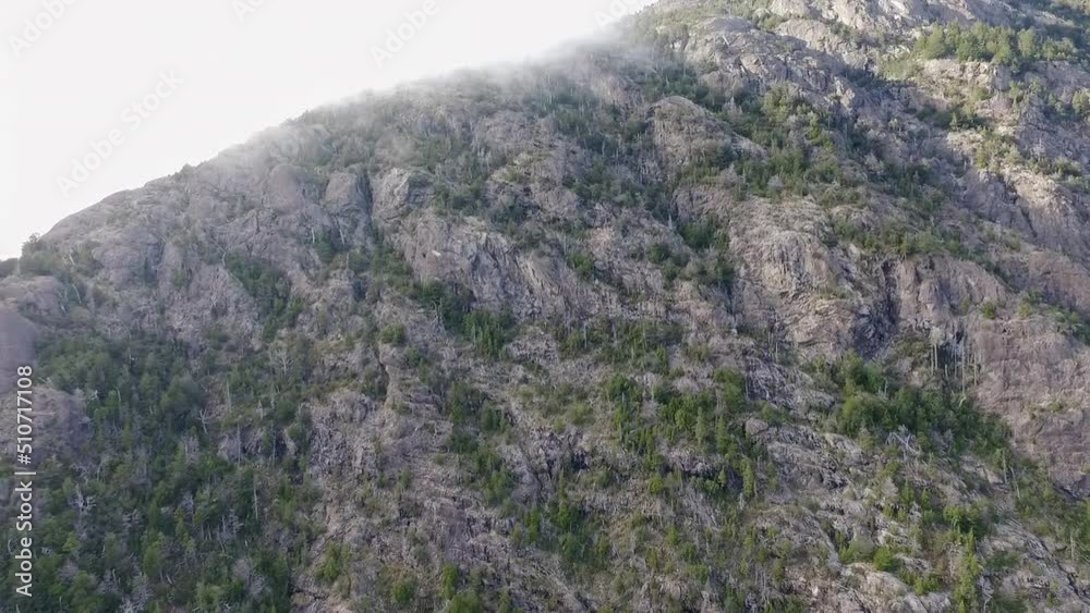 Alpine landscape. Aerial view of the rocky mountains peak touching the clouds, and green forest. Alpine landscape. Aerial view of the rocky mountains peak touching the clouds, and green forest.
