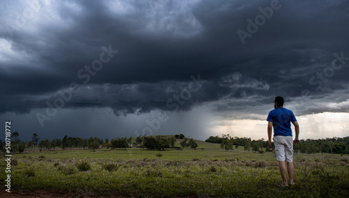 Storm Clouds, man watching a storm in the field © asaffsouza