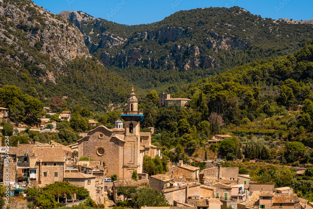 Photograph of the church of the town of Valldemossa on the Island of Mallorca from a distance on a sunny day