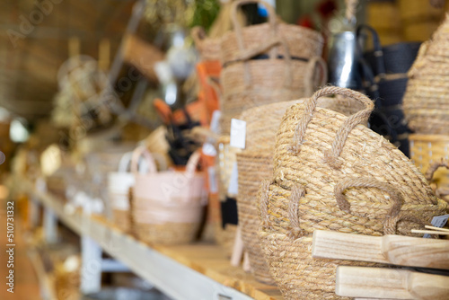 Wicker baskets and other handmade items on store shelves closeup