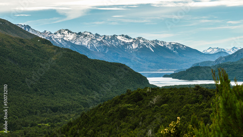 View from the top of a river going through a forest and flowing into a lake in the Andes mountain range. Calihuel River Rivadavia Lake. Chubut  Argentina