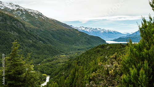 Obraz na płótnie View from the top of a river going through a forest and flowing into a lake in the Andes mountain range. Calihuel River Rivadavia Lake. Chubut, Argentina w salonie