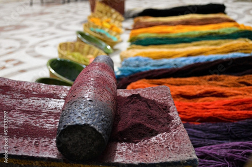 Preparation of organic colors, pigments of natural origin, ground in stone. Concept, artisans grind plants to obtain colors