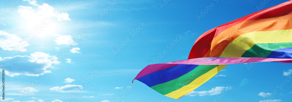 Rainbow flag on sky background. LGBT concept.