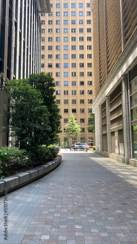 Central downtown Tokyo business district, Otemachi, little path behind the skyscrapers, looking up, year 2022 June 13th sunny weekday