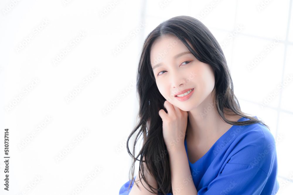 Fototapeta premium Woman grooming hair, looking at camera