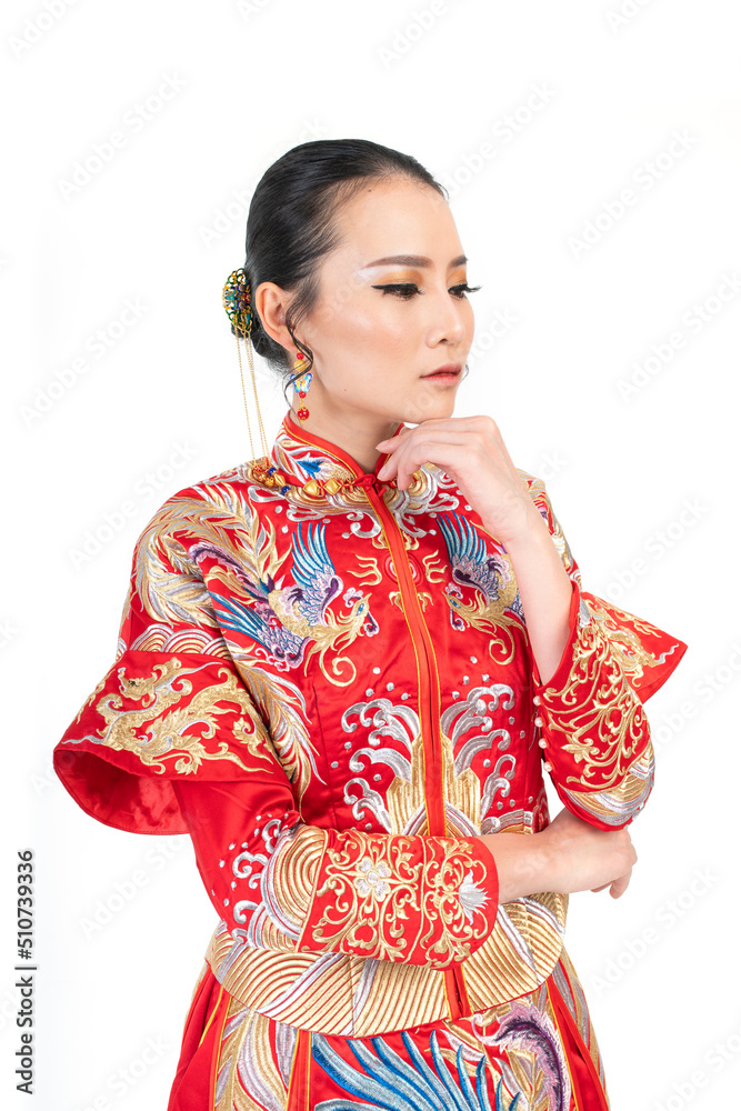 Portrait of a young asian Chinese female lady model wearing red traditional vintage wedding dress costume smiling and posing with different poses and gestures 