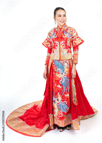 Portrait of a young asian Chinese female lady model wearing red traditional vintage wedding dress costume smiling and posing with different poses and gestures 