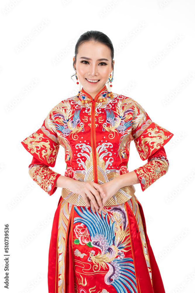 Fototapeta premium Portrait of a young asian Chinese female lady model wearing red traditional vintage wedding dress costume smiling and posing with different poses and gestures
