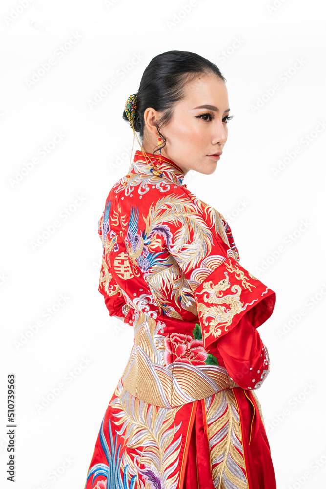 Portrait of a young asian Chinese female lady model wearing red traditional vintage wedding dress costume smiling and posing with different poses and gestures 