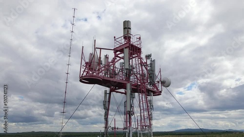 Aerial view of telecommunications cell phone tower with wireless communication antennas for network signal transmission