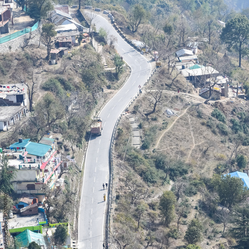 Aerial top view of traffic vehicles driving at mountains roads at Nainital, Uttarakhand, India, View from the top side of mountain for movement of traffic vehicles photo