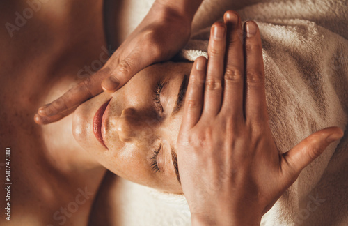 Beautiful woman in spa salon getting face massage treatment. Girl facial treatment. Skin care. Body care.