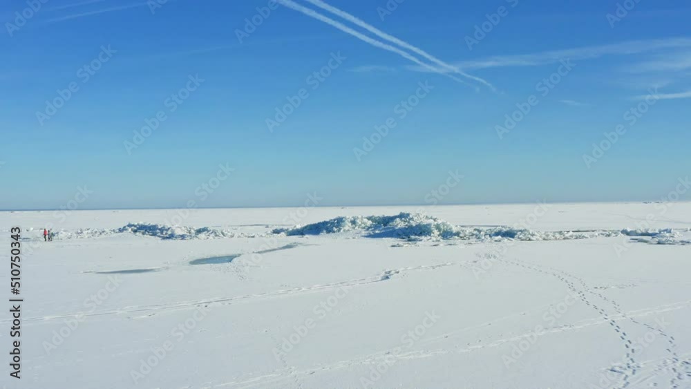 Fast flyover above frozen lake near Audru, Estonia. Drone descending then rising up Fast flyover above frozen lake near Audru, Estonia. Drone descending then rising up