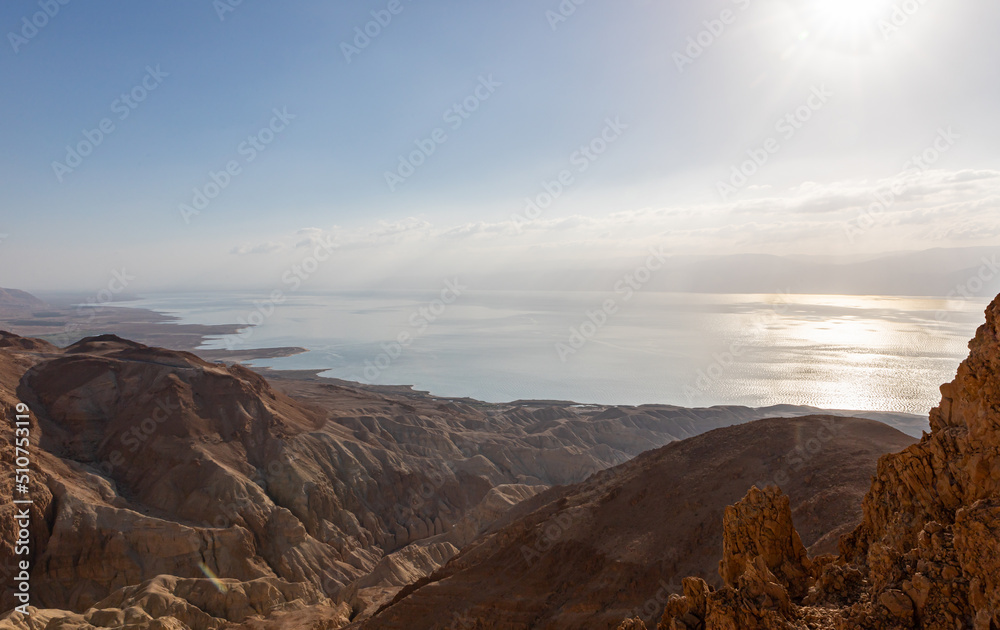 Obraz premium Sunrise over the Dead Sea near mountains of stone desert near the Khatsatson stream, on the Israeli side of the Dead Sea, near Jerusalem in Israel