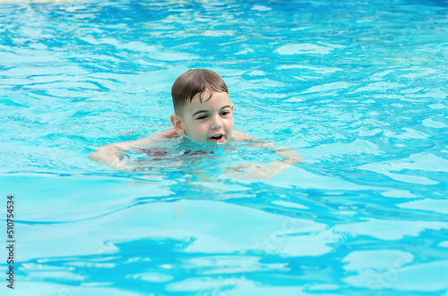 a boy swims in the pool